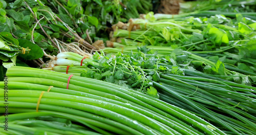 Quadro su tela Bundled fresh green onions (Allium fistulosum), celery (Apium graveolens), cilantro (Coriandrum sativum), and mint (Mentha) displayed at a market stall