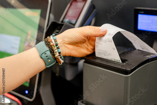 Obraz na płótnie Customer taking printed receipt from self service machine