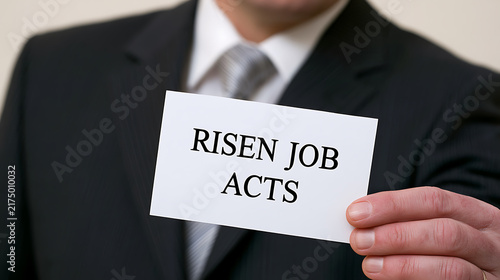A business professional in suit holding a white card with text text message close up view for corporate presentation and career concept