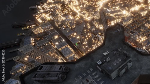 Many buildings are lit up in a city at night with lights shining. Some areas of the city are dark while others are bright. A road runs through the view above the buildings.