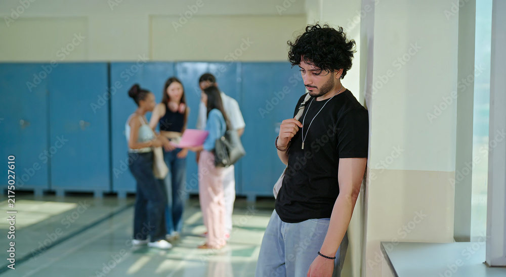 Fototapeta premium Indian sad young adult gen z man guy wear bag feel low look upset fail in study exam result indoor campus place alone lost tensed male boy suffer mental health issue social bully live bad hostel life