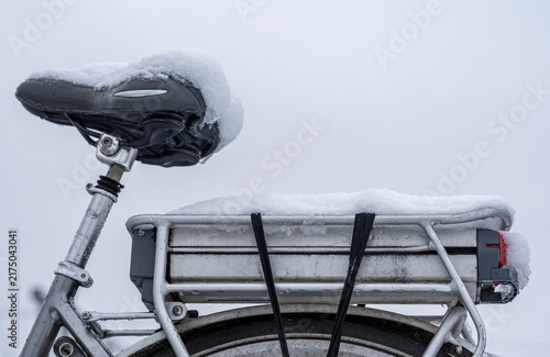 e-bike battery covered in snow and ice during cold winter weather