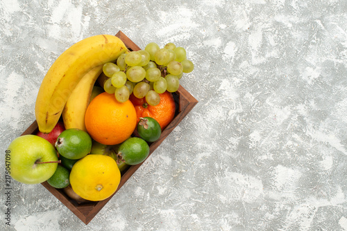 top view fresh fruit composition bananas grapes and feijoa on white background fruit mellow vitamine health fresh