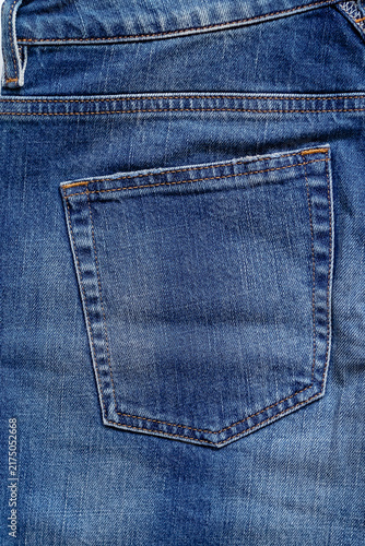 Detailed denim back pocket showcasing precise stitching and the rich texture of woven blue fabric.