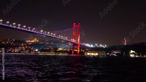 Scenic Night View of the Illuminated Bosphorus Bridge and Camlica TV Tower with Grand Camlica Mosque in Background Reflected on Bosphorus Sea Water, Iconic Landmark Cityscape in Istanbul, Turkey
