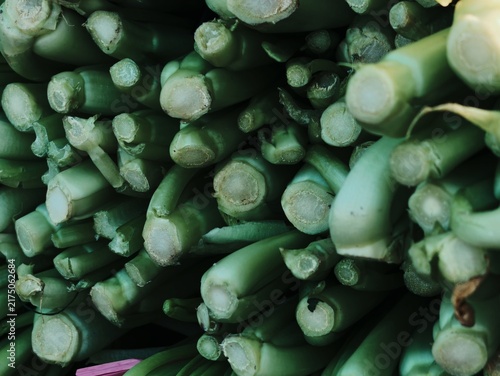 Canvas Print Close up full frame view of bundled fresh green vegetable stalks at a market