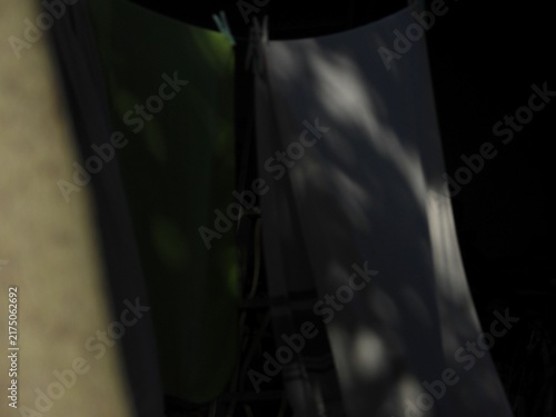Картината върху платно Two large fabrics hang vertically, one green and one white
