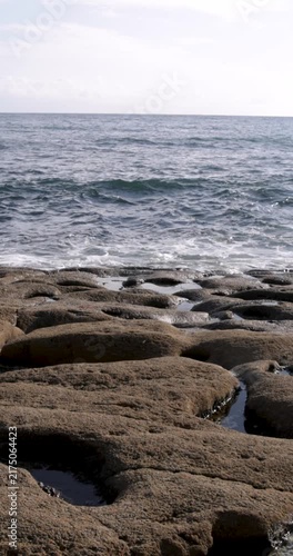 Gentle ocean waves splashing on a rocky coast