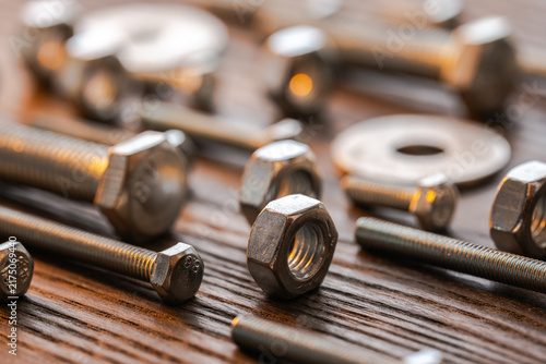 Metal nuts bolts washers fasteners on wood