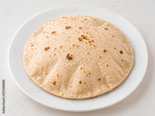 Fully Puffed Roti with Toasted Spots on White Plate