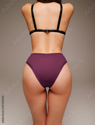 Bild auf Leinwand Back view of woman wearing purple high waist panties and black bra