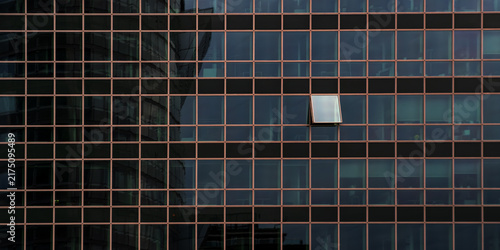 Bild auf Leinwand One open window on a modern office building facade standing out from the crowd