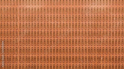 Картината върху платно Seamless pattern of numerous metal paper clips arranged in neat rows against a w
