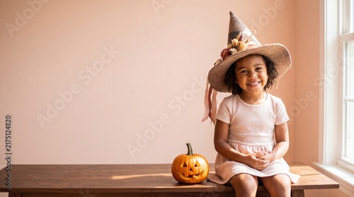 Happy Girl Smiling Beside Carved Halloween Pumpkin