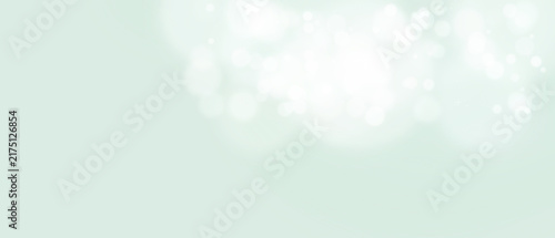 Bokeh background Soft white glowing circles on a light green with shine