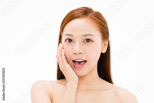 Foto Surprised young woman touching her cheek on white background