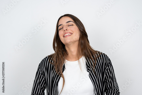 Fotografía Smiling young woman relaxed with closed eyes in casual striped shirt portrait ex