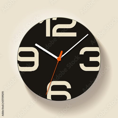 Modern black wall clock with large cream numbers, white hands and bright orange second hand on a neutral beige background. Minimal contemporary clock design with soft long shadow, suitable for time