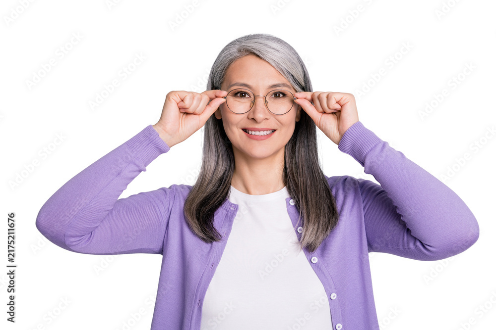Obraz premium Portrait photo of positive smiling elder woman touching keeping wearing eyeglasses in ophthalmology clinic isolated on grey color background