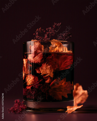 Autumn leaves submerged in decorative glass arrangement