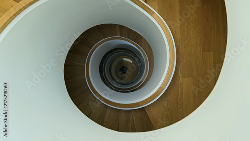 Фотография A top-down perspective of a wooden spiral staircase winding gracefully downwards