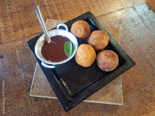 Foto Gourmet meat Croquettes with Dipping Sauce on Rustic Table