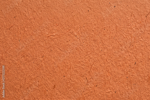 Terracotta orange handmade paper texture background with rough fiber detail