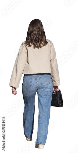 Quadro su tela Jeune femme vue de dos marchant avec un sac à main, veste beige et jean bleu, en