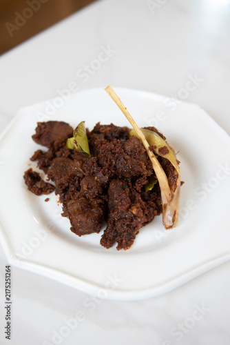 Quadro su tela Plated grilled beef served as a savory main course on a white ceramic plate, photographed against a clean light background