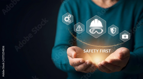 Occupational health and safety concept showing cupped hands with glowing Safety First text and digital icons for protective gear, risk prevention, and workplace security.