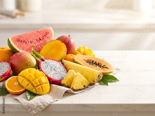 A vibrant assortment of fresh tropical fruits on a kitchen counter