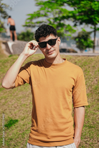 Stylish Young Man Enjoying a Summer Day by the Beach
