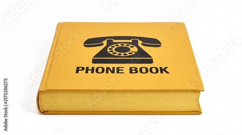 Vintage yellow phone book with black rotary telephone icon positioned flat on white background