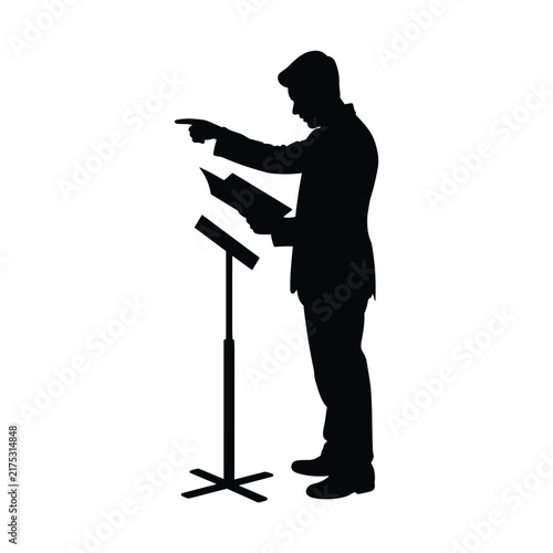 Black silhouette of professional man standing at podium giving speech while pointing forward