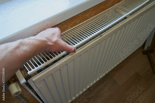 Obraz na plátně Man removing top grill of radiator for cleaning or maintenance, Close up of male