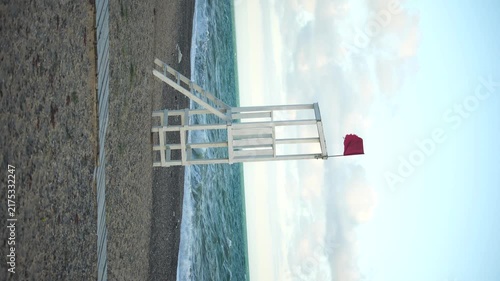 Lifeguard Chair Beach Red Flag Warning - A lifeguard chair with a red flag warning on the beach.