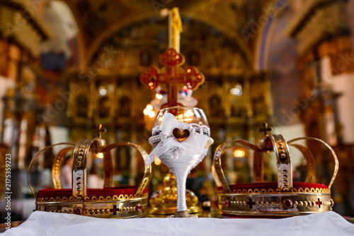 Принти на полотні Two crowns, a cup of wine and a cross prepared for baptism