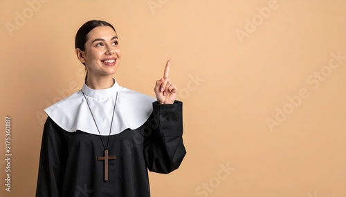 Priest in cassock pointing upward on beige background, space for text
