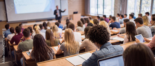 Full lecture hall with student audience at university college, back to school conference presentation room, training seminar meeting
