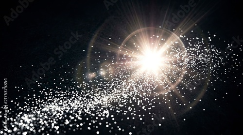 Abstract Sparkling Glitter Dust Trail with Bright Glowing Lens Flare on Dark Background for Celebration and Magic Concepts