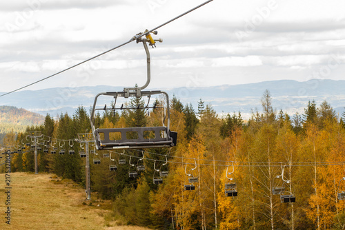 Canvas Print Empty chairlift over autumn mountain forest landscape
