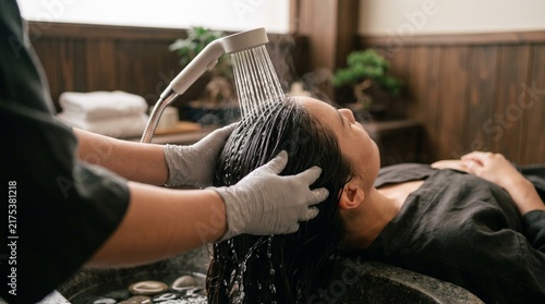 Woman receiving a hair wash at a Japanese head spa with soothing care  