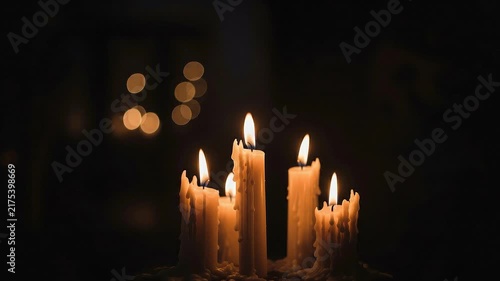 A seamless pattern burning candles in the dark