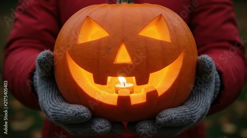 A seamless pattern person holding a glowing carved jackolantern pumpkin
