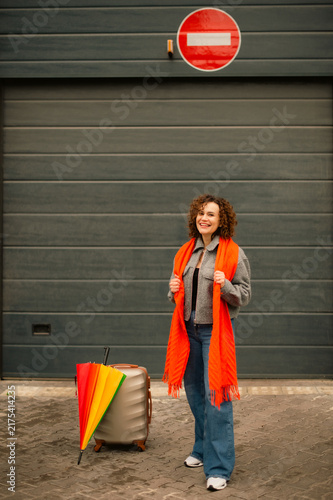 Konstfotografi Tourist woman with suitcase standing at closed garage exit with no entry sign in
