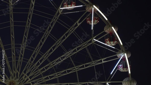 Close Up of Ferris Wheel Structure and Gondolas at Night