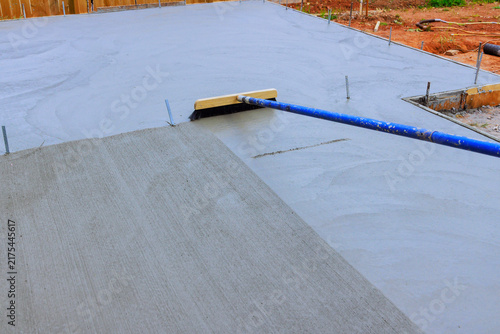 Принти на полотні Workers are using broom tool to level wet concrete on construction site is residential area