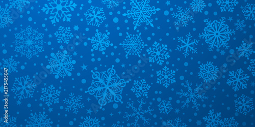 Vibrant blue Christmas background with intricate snowflake designs and scattered dots, creating a festive winter atmosphere.