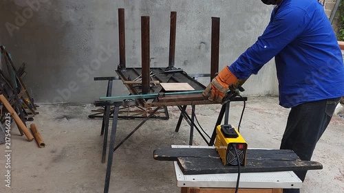 Removing Scrap Metal Pieces from Table Frame to Continue Welding