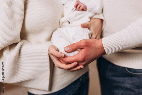 Canvastavla A Tender Embrace: Parents' hands gently cradle and protect their newborn baby, symbolizing the profound love and bond of family